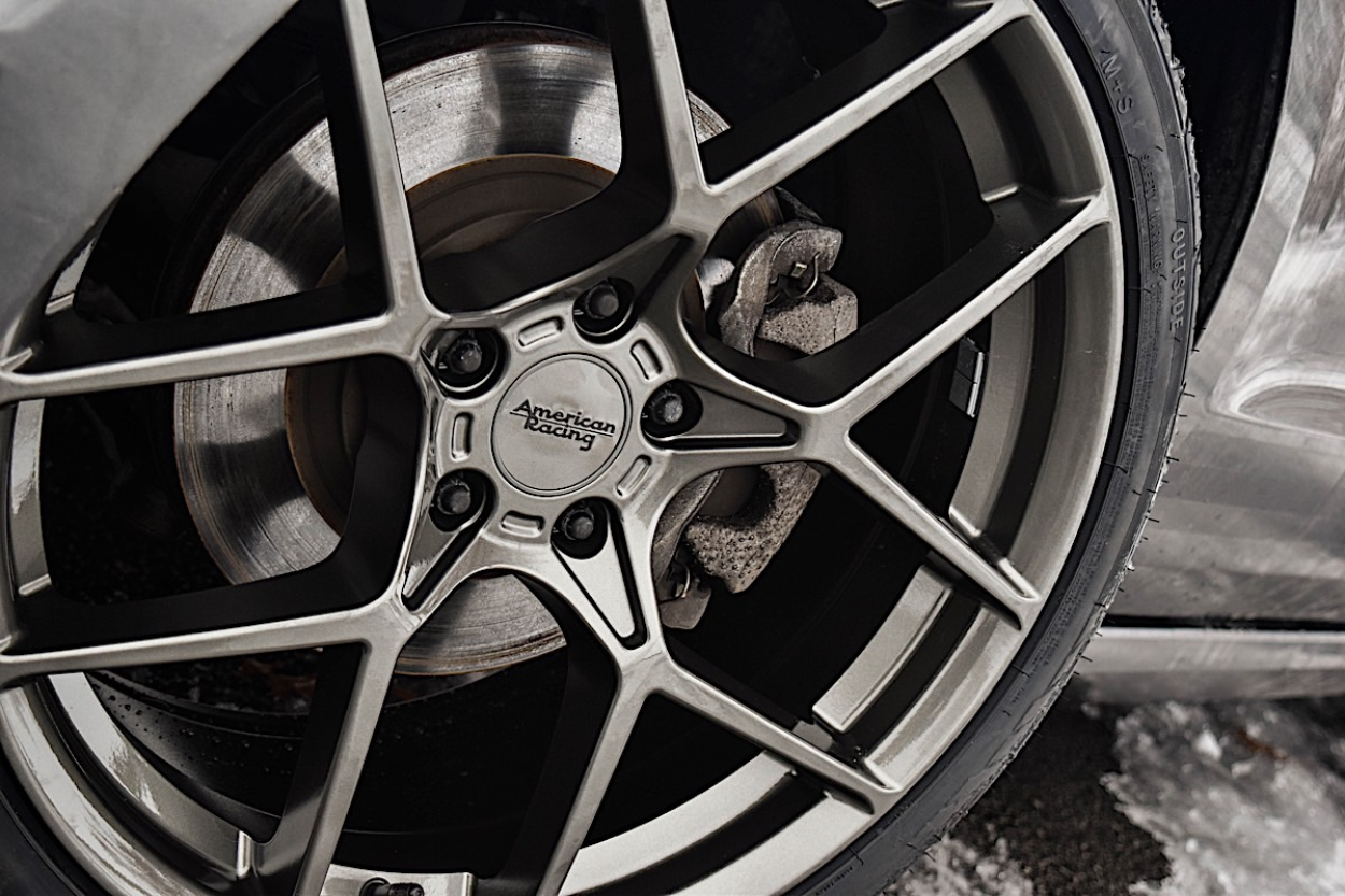 2013 Ford Mustang V6 wheels with American Racing Crossfire rims.